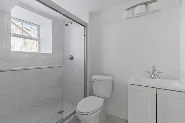 a white toilet sitting next to a bathroom sink