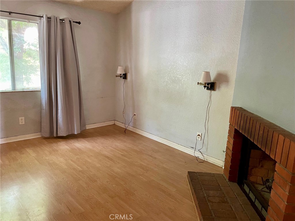 1077 South Santo Antonio Drive, Unit 15 Colton, CA 92324 - Photo 14 of 20 a view of an empty room with a fireplace