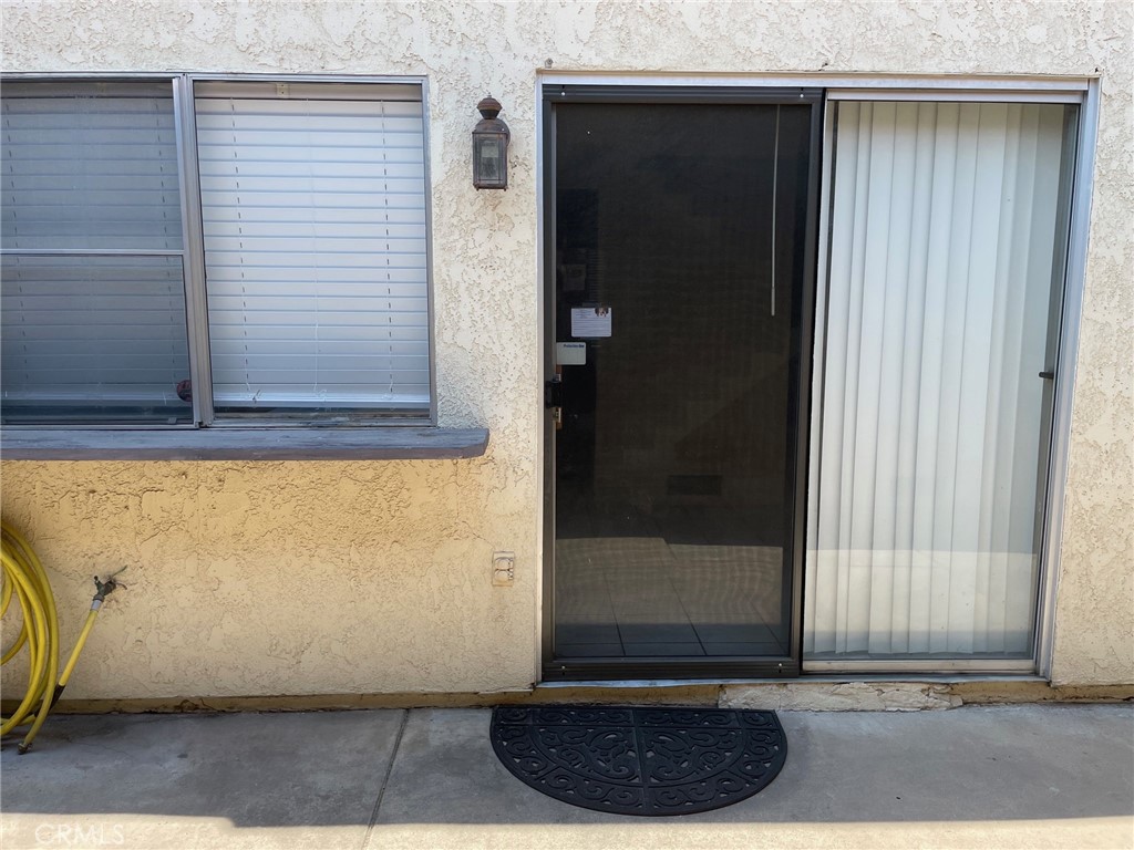 1077 South Santo Antonio Drive, Unit 15 Colton, CA 92324 - Photo 19 of 20 a view of a door and a window