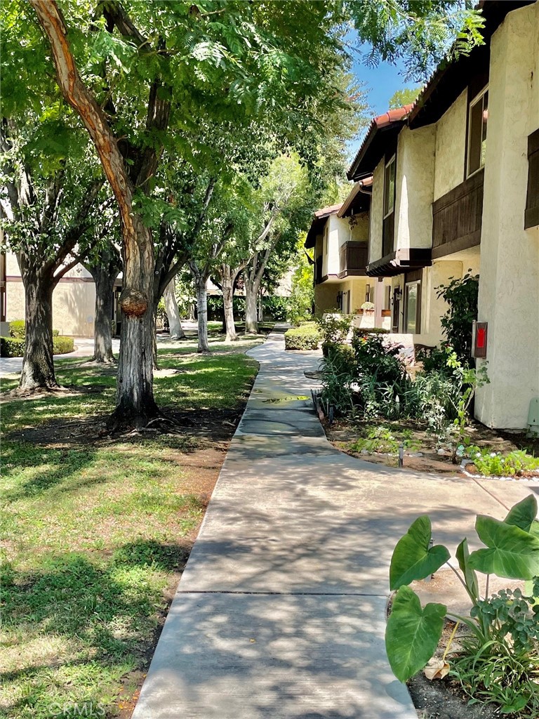 1077 South Santo Antonio Drive, Unit 15 Colton, CA 92324 - Photo 2 of 20 a front view of a house with garden