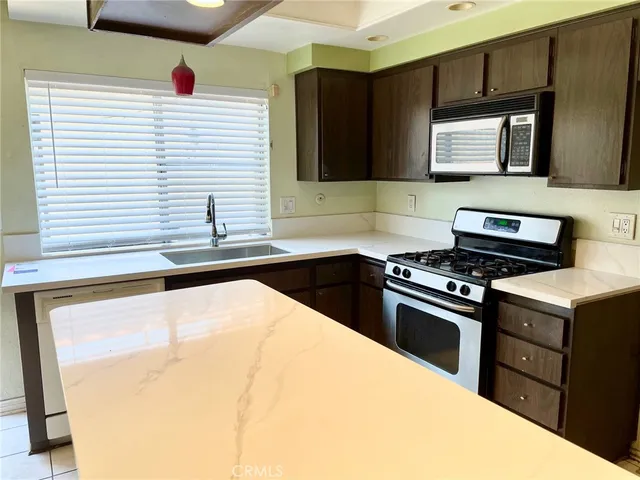 a kitchen that has a sink and a stove