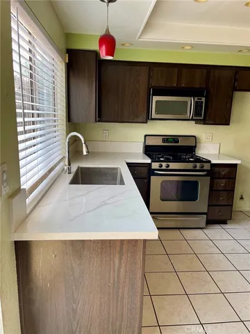 a kitchen with a sink a stove and cabinets