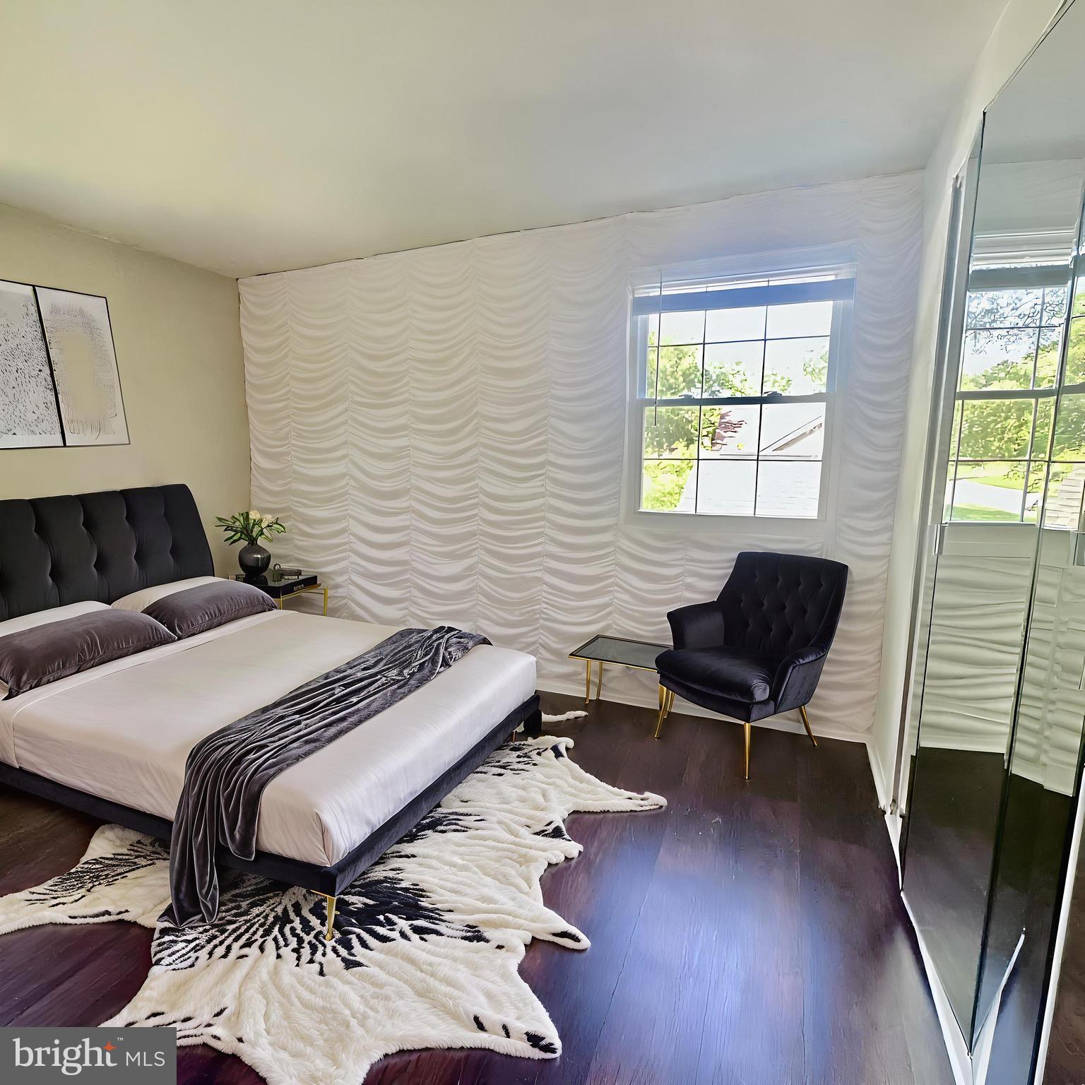 8908 Eastbourne Lane Laurel, MD 20708 - Photo 14 of 26 a bedroom with a bed and wooden floor