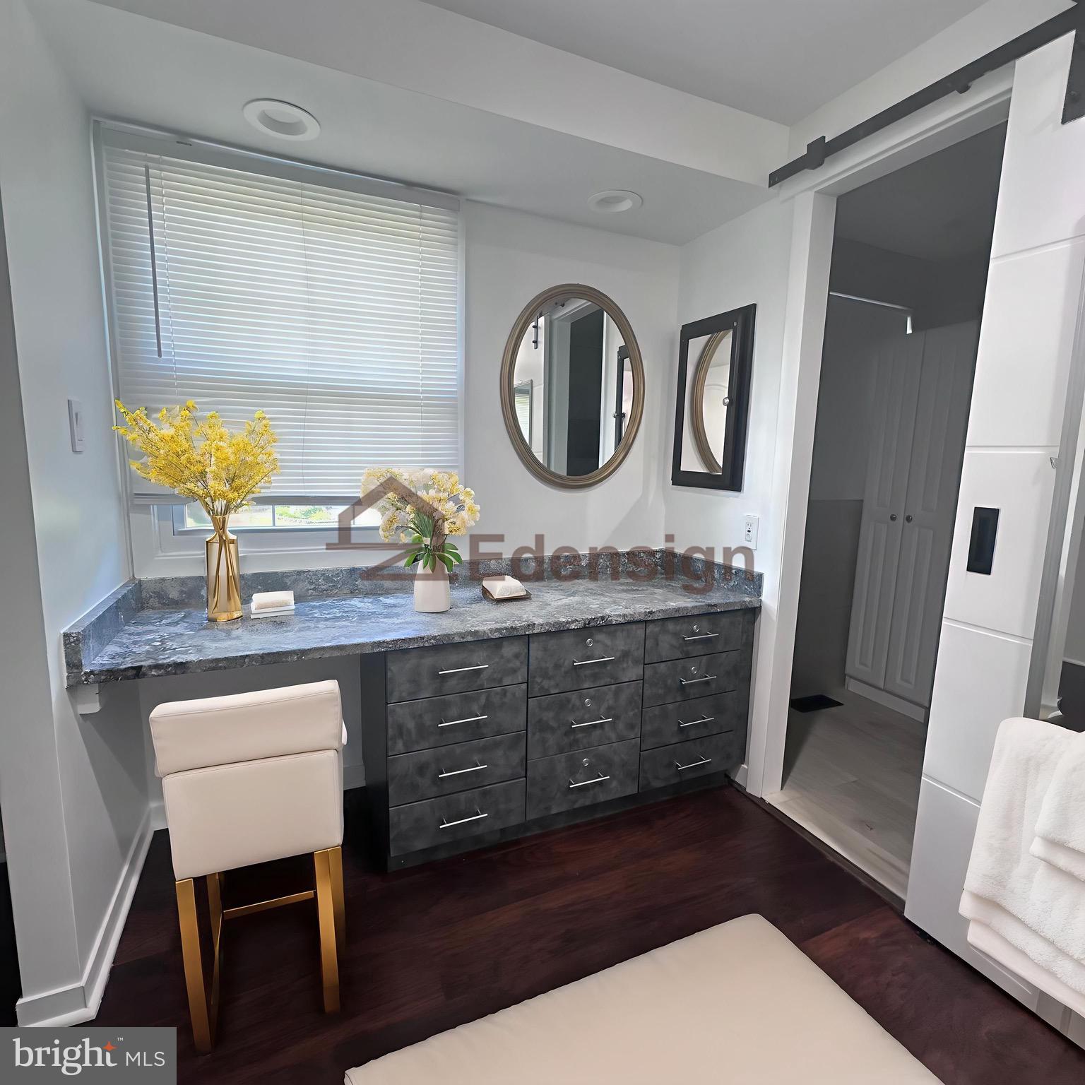 8908 Eastbourne Lane Laurel, MD 20708 - Photo 17 of 26 a bathroom with a granite countertop sink a mirror and a vanity