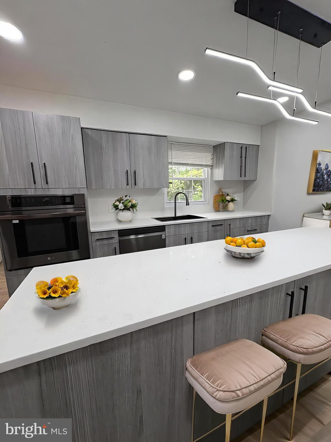 8908 Eastbourne Lane Laurel, MD 20708 - Photo 6 of 26 a kitchen with a table and chairs