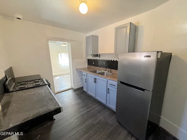 a kitchen that has a sink and a stove in it