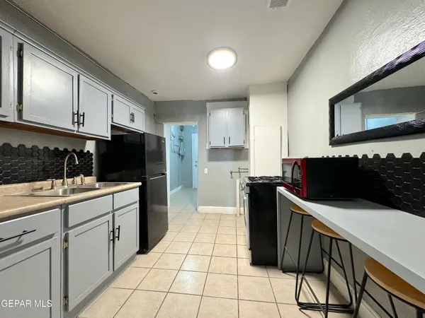 a kitchen with stainless steel appliances a stove a microwave and a counter top