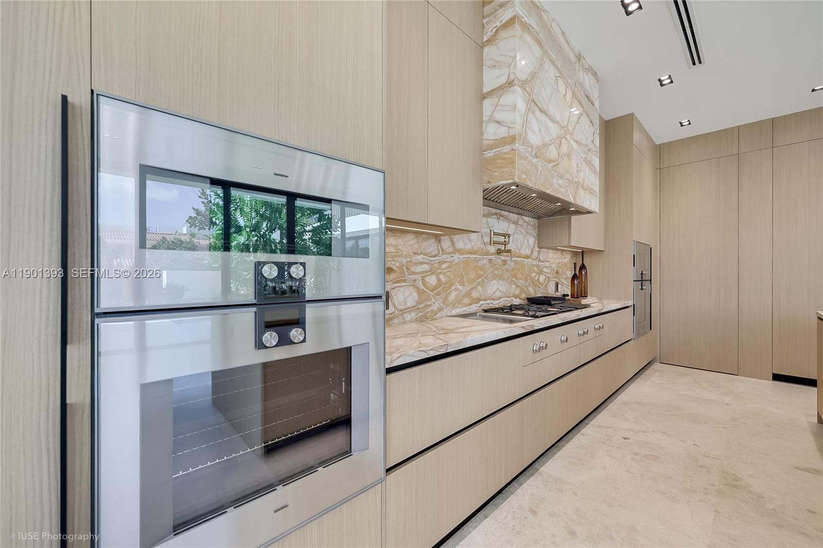770 Lake Road Miami, FL 33137 - Photo 17 of 40 a kitchen with stainless steel appliances granite countertop a refrigerator and a stove