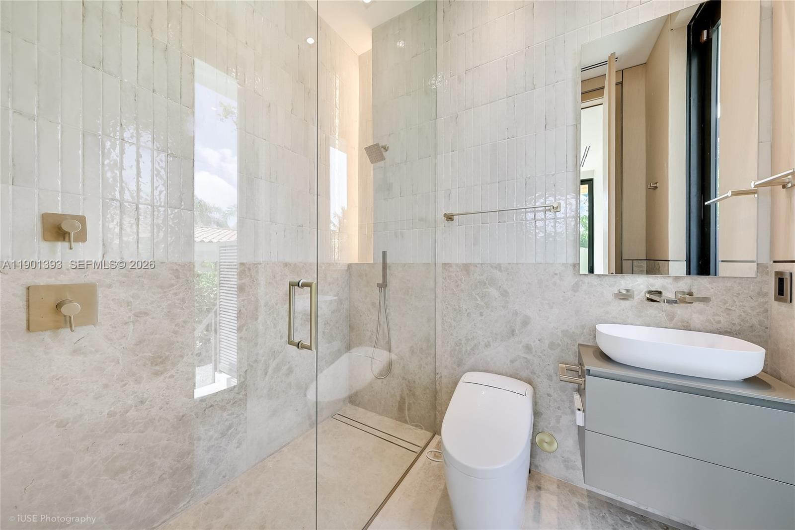 770 Lake Road Miami, FL 33137 - Photo 21 of 40 a bathroom with a granite countertop sink a toilet and shower