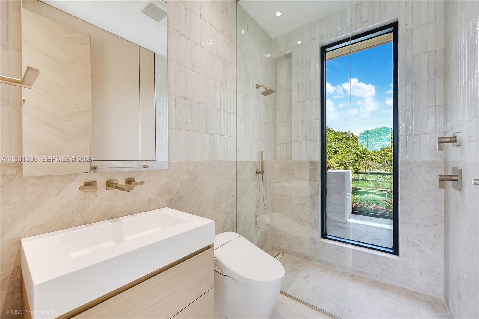 770 Lake Road Miami, FL 33137 - Photo 28 of 40 a bathroom with a sink a toilet and shower