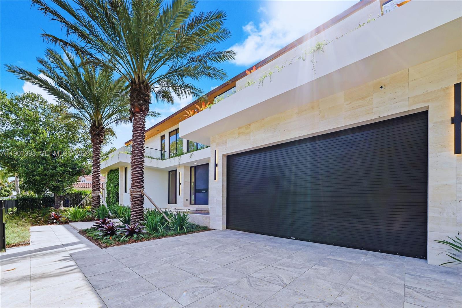 770 Lake Road Miami, FL 33137 - Photo 36 of 40 a backyard of a house with potted plants and palm trees