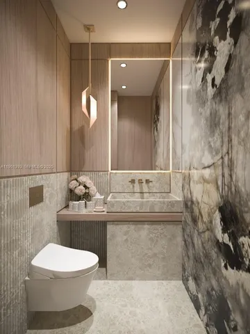 a bathroom with a toilet sink and mirror