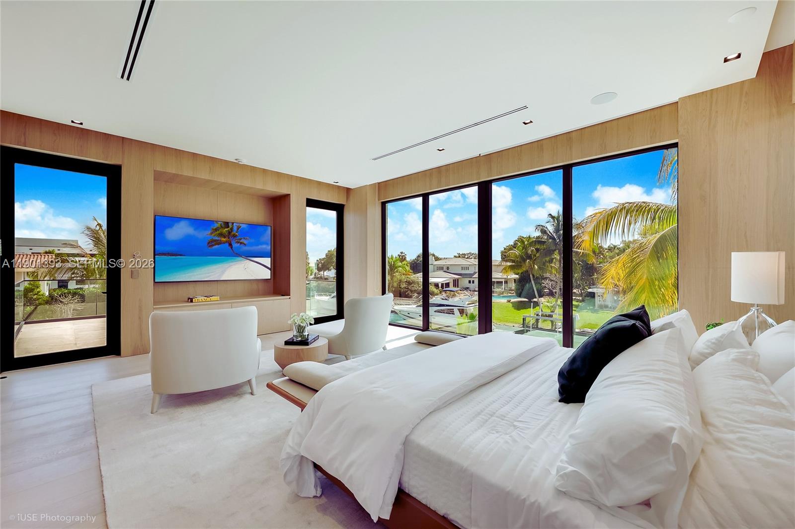 770 Lake Road Miami, FL 33137 - Photo 9 of 40 a bedroom with a large bed and a flat tv screen on dresser