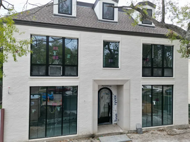 a front view of a house with glass windows