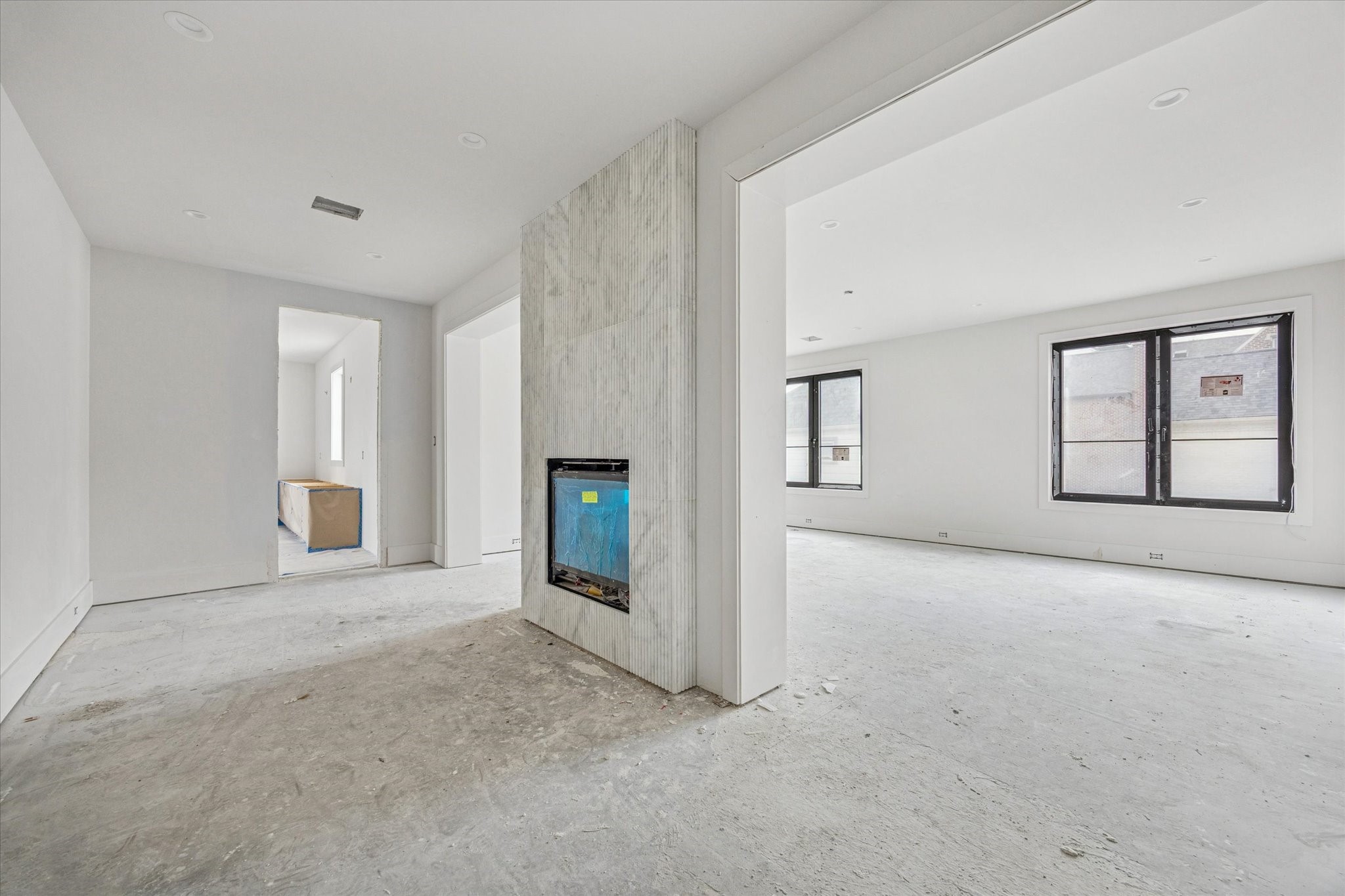 2217 Pelham Drive Houston, TX 77019 - Photo 15 of 21 Large primary suite with fireplace encased with fluted marble, sitting area, and large bedroom.