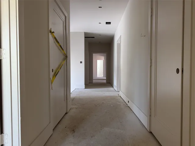 a view of a hallway with wooden floor and stairs