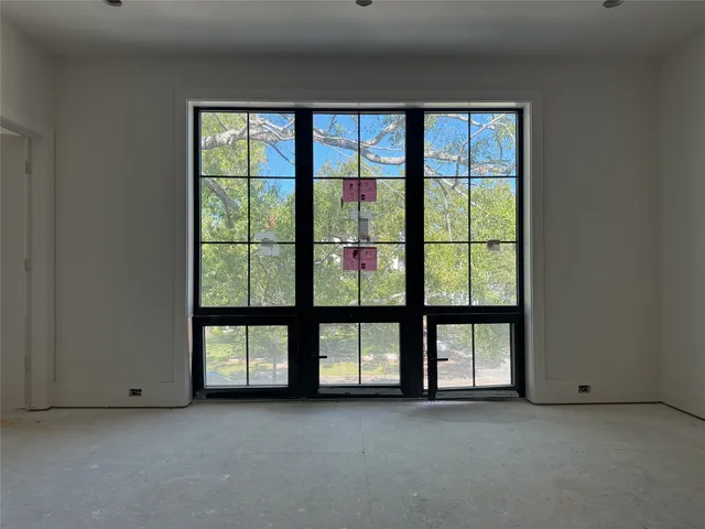an empty room with windows and city view