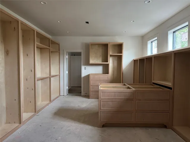 a kitchen with cabinets and refrigerator