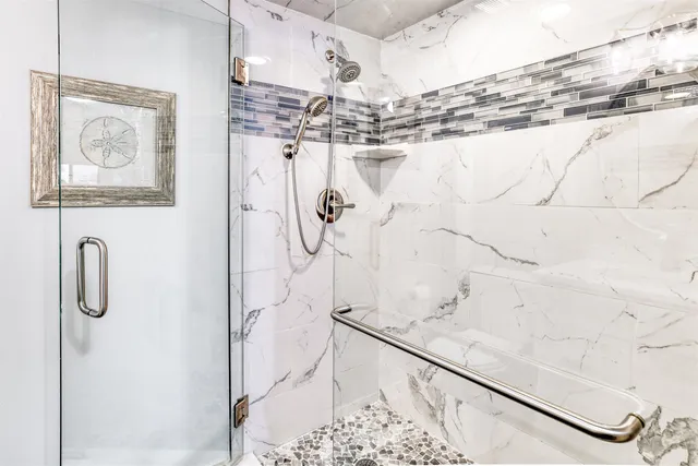 a bathroom with a shower and a mirror of shower