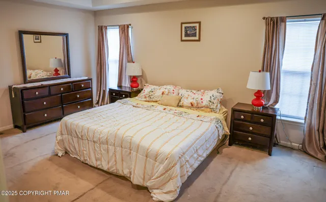 a bedroom with a bed and a mirror on dresser