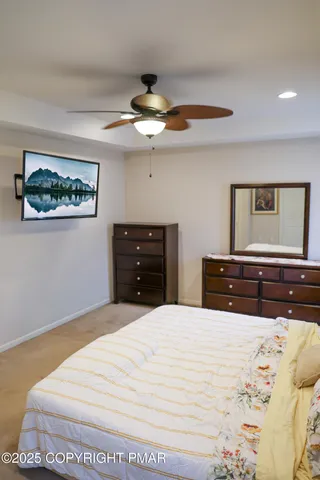 a bedroom with a bed and a dresser