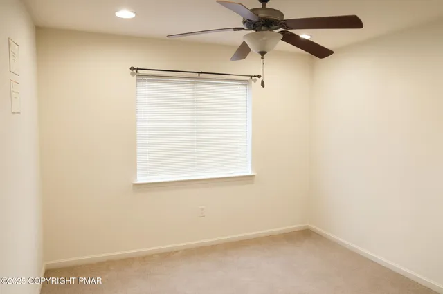 a view of a small space with a window and a fan