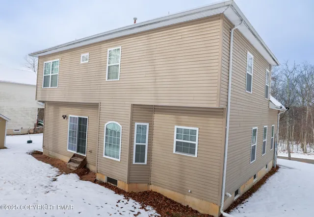 a front view of a house with large windows