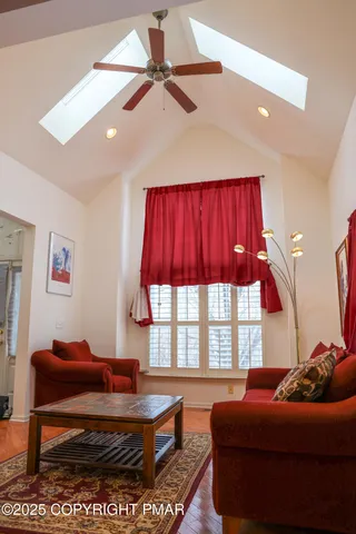 a living room with a bed furniture and a large window