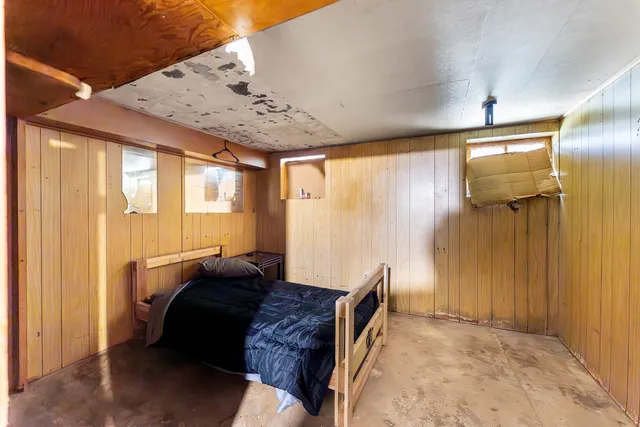 a spacious bedroom with a bed and a window