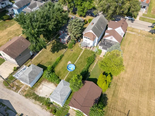 an aerial view of a house with garden space and swimming pool