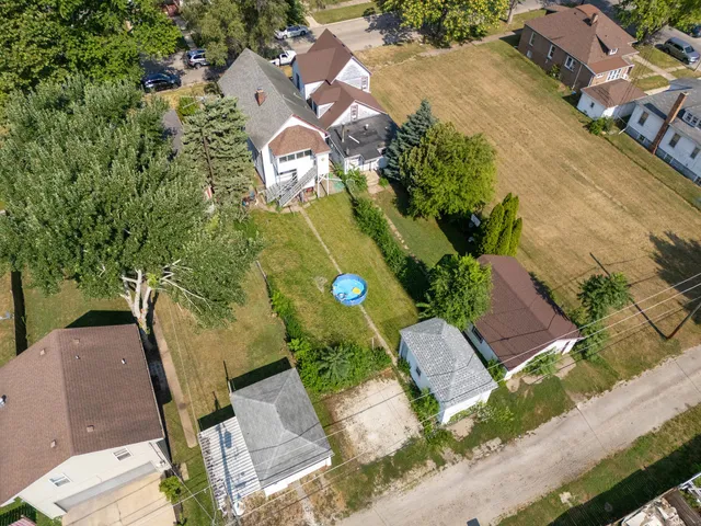 an aerial view of a house with garden space and street view