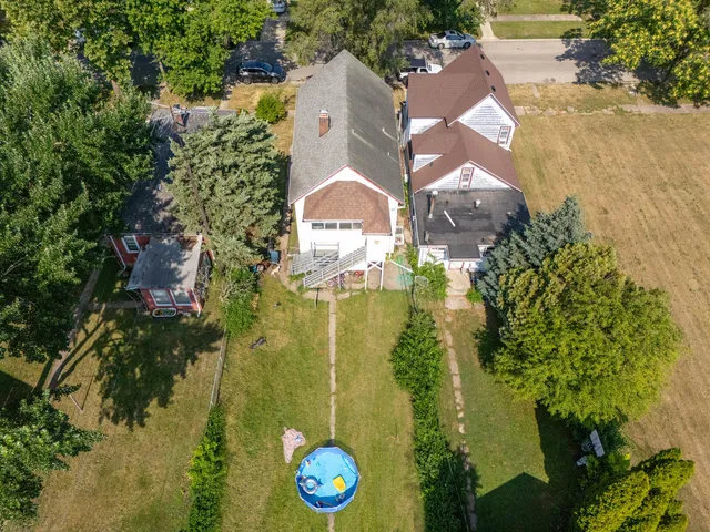 an aerial view of a house with a yard
