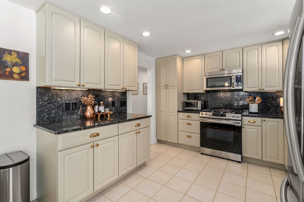 193 Gorwin Drive Holliston, MA 01746 - Photo 11 of 23 a kitchen with stainless steel appliances granite countertop a stove a sink and a refrigerator