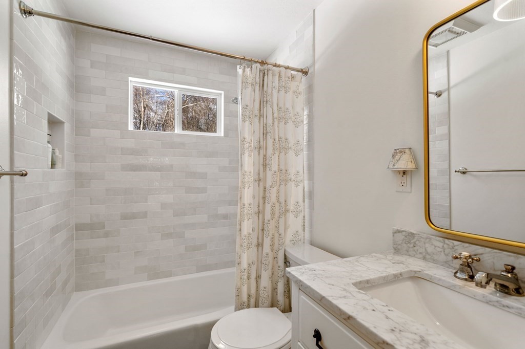 193 Gorwin Drive Holliston, MA 01746 - Photo 16 of 23 a bathroom with a granite countertop sink toilet and shower