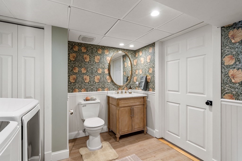 193 Gorwin Drive Holliston, MA 01746 - Photo 19 of 23 a bathroom with a toilet sink and mirror