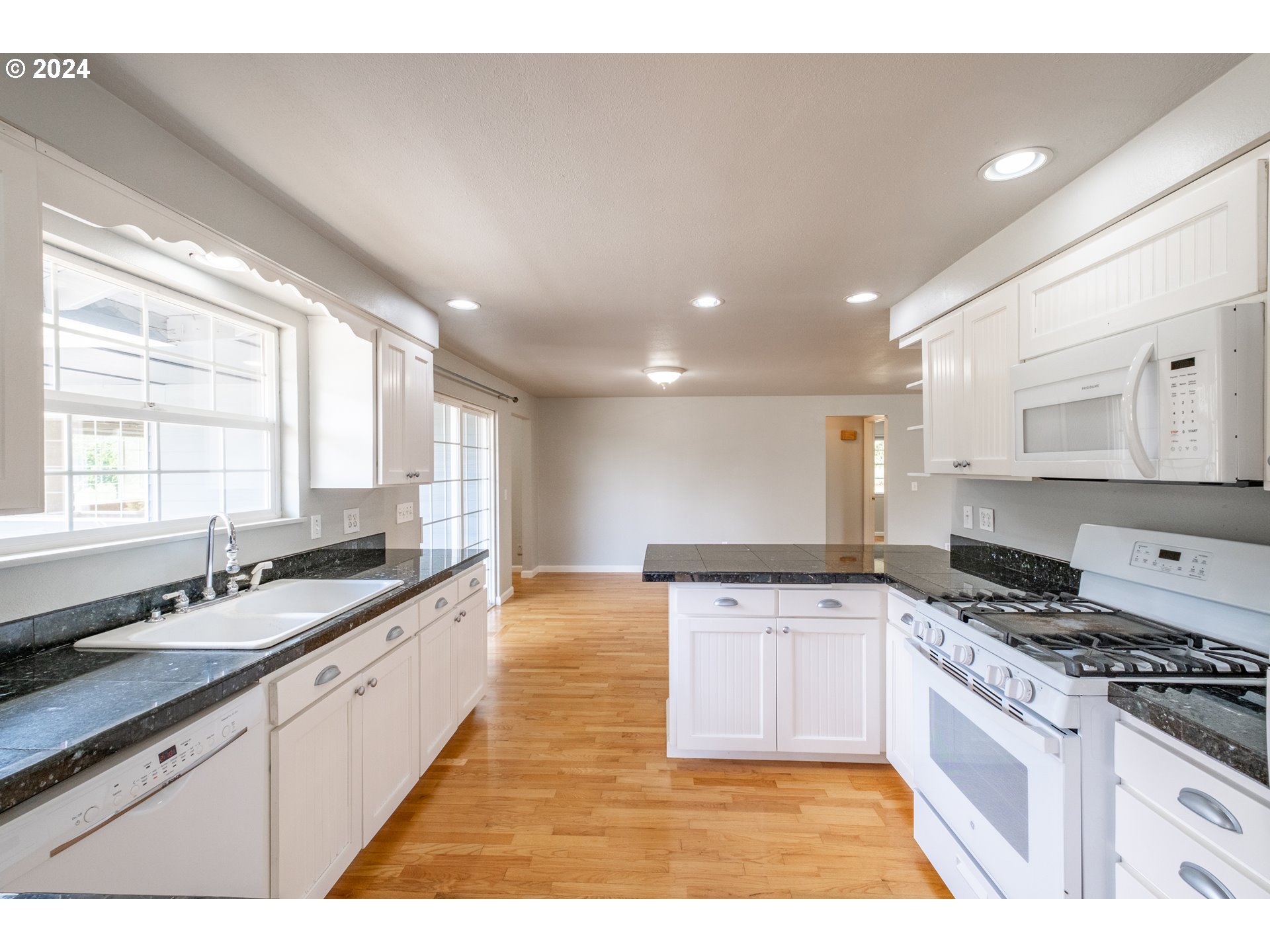 30521 Rancho Road Lebanon, OR 97355 - Photo 13 of 39 a large kitchen with stainless steel appliances kitchen island granite countertop a sink and cabinets