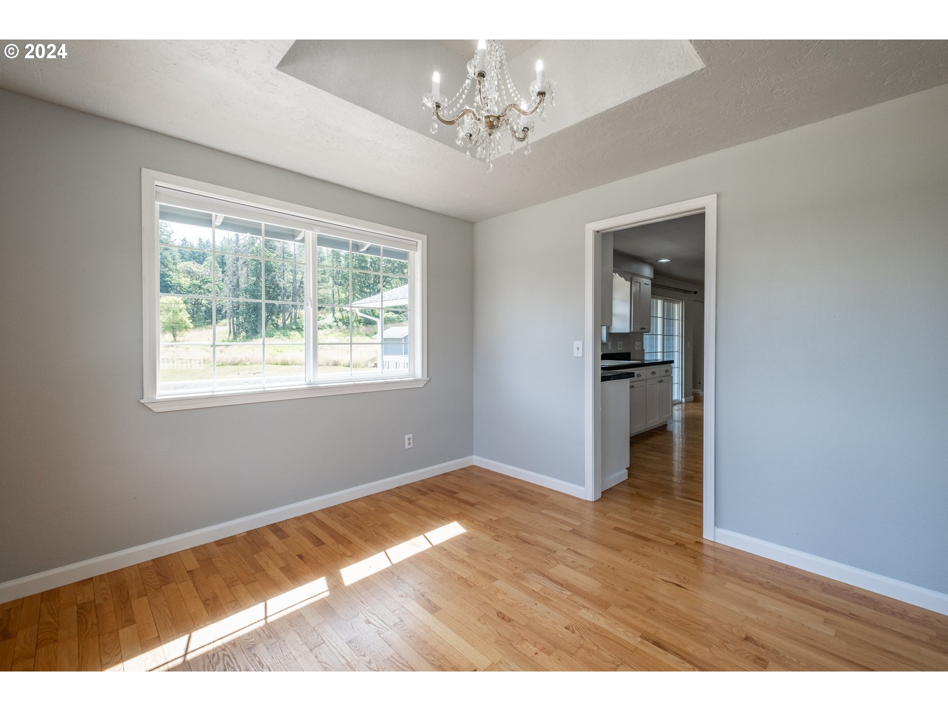 30521 Rancho Road Lebanon, OR 97355 - Photo 15 of 39 a view of empty room with window and wooden floor