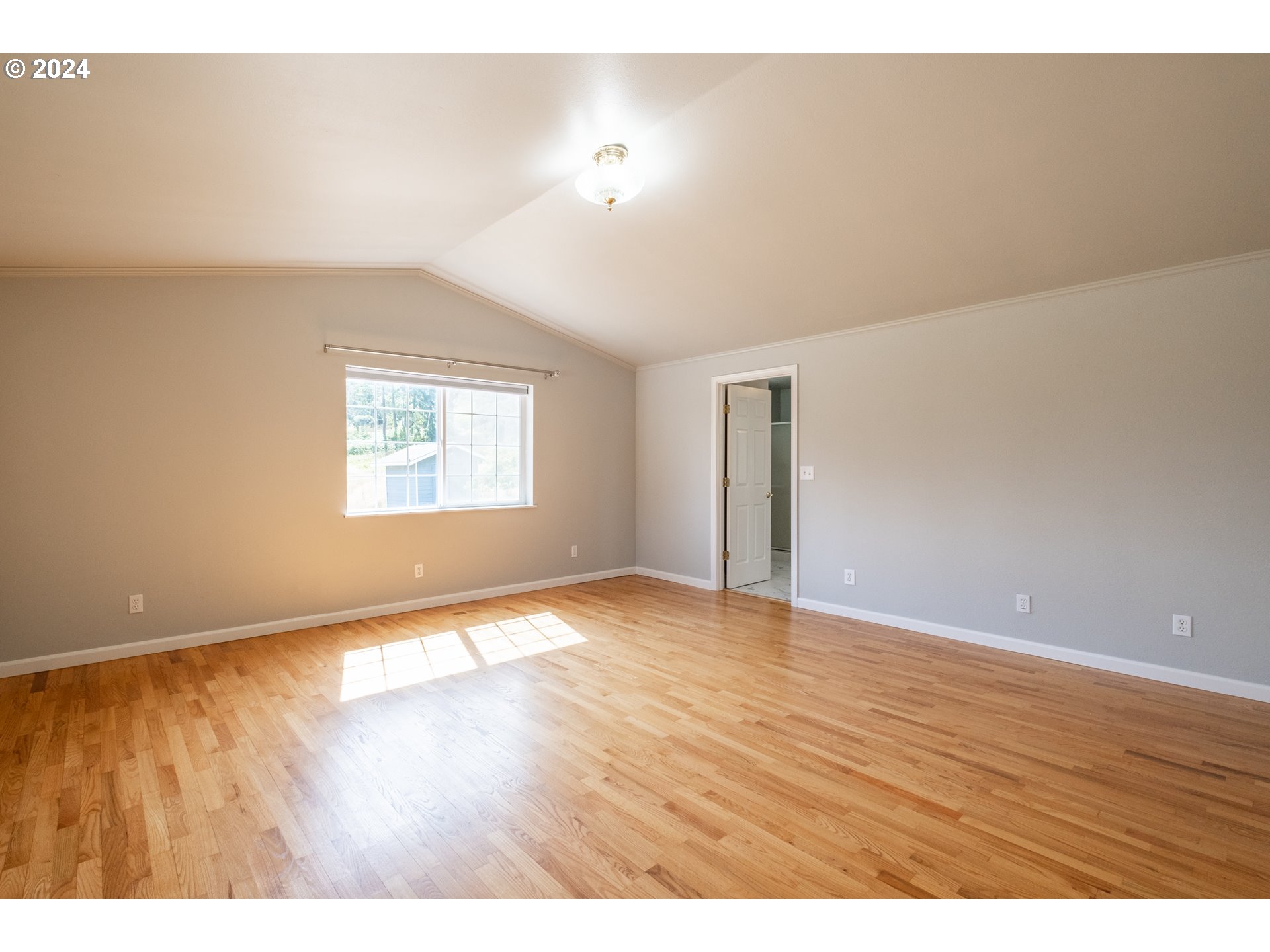 30521 Rancho Road Lebanon, OR 97355 - Photo 18 of 39 a view of an empty room with wooden floor and a window