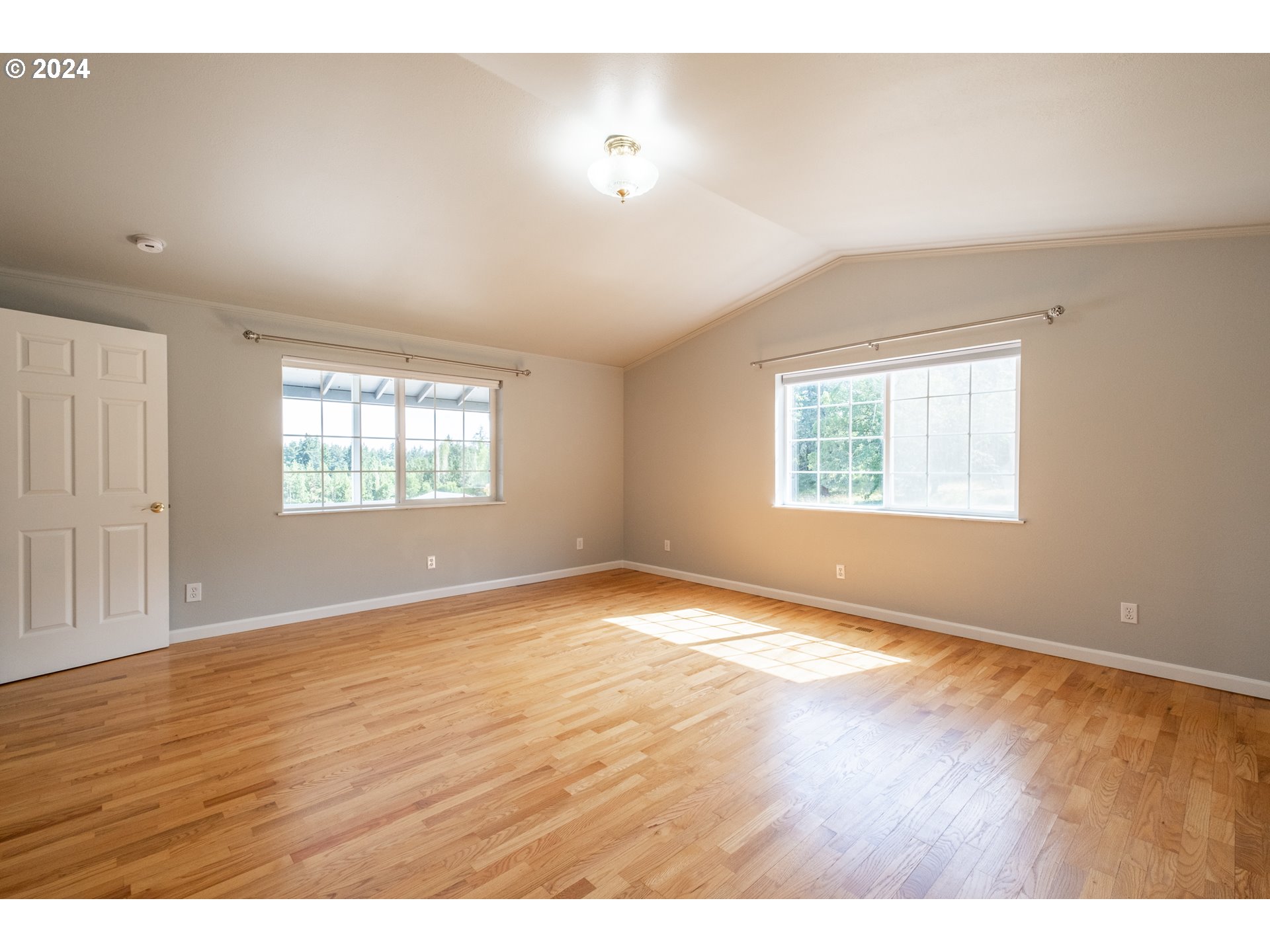 30521 Rancho Road Lebanon, OR 97355 - Photo 19 of 39 an empty room with wooden floor and windows