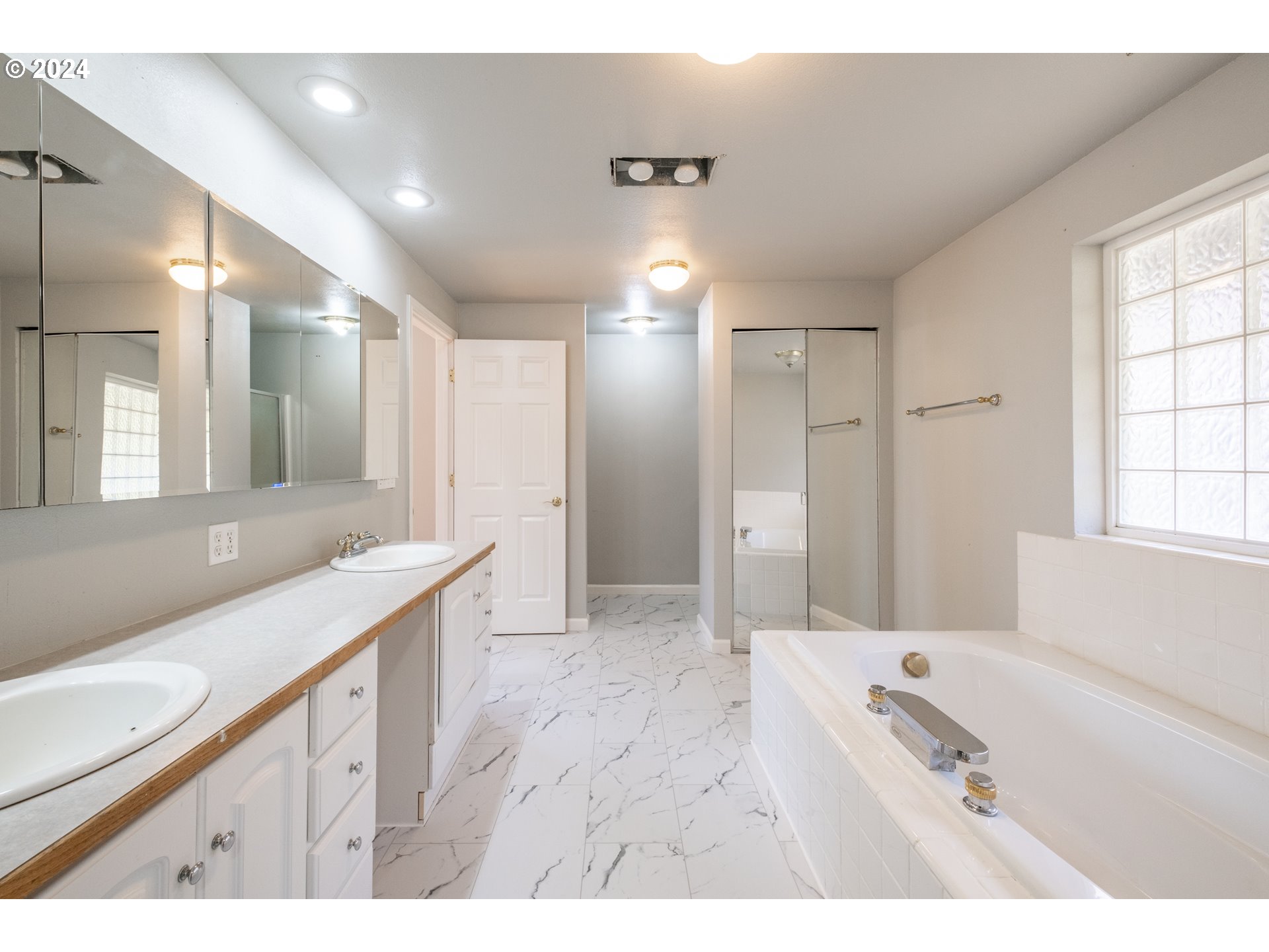 30521 Rancho Road Lebanon, OR 97355 - Photo 20 of 39 a bathroom with a sink a large mirror and a shower