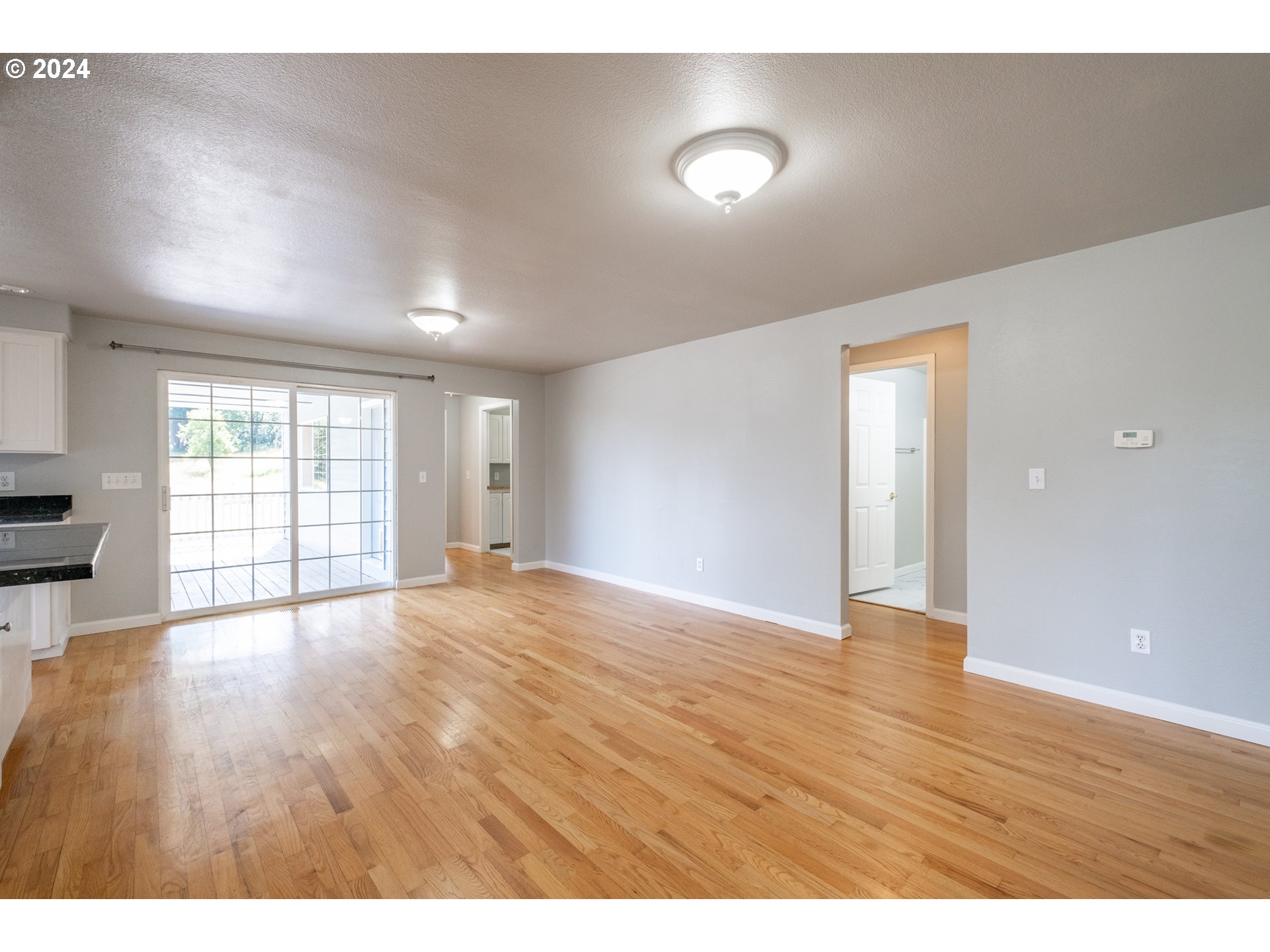 30521 Rancho Road Lebanon, OR 97355 - Photo 22 of 39 a view of an empty room with wooden floor and a window