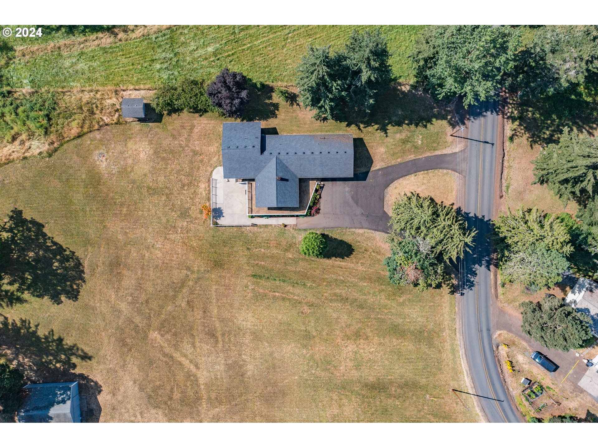 30521 Rancho Road Lebanon, OR 97355 - Photo 38 of 39 a view of a house with a yard and potted plants