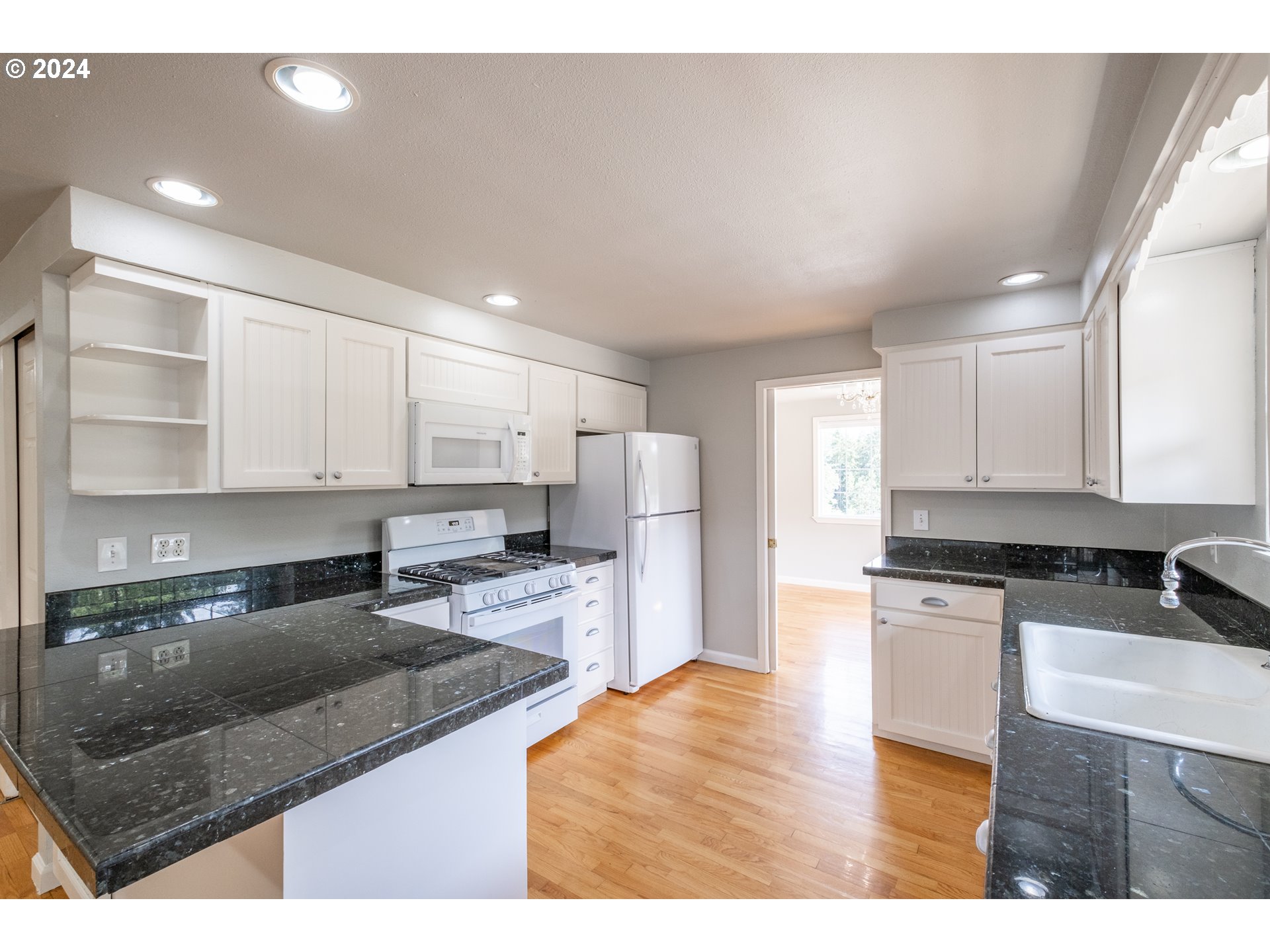 30521 Rancho Road Lebanon, OR 97355 - Photo 10 of 39 a kitchen with stainless steel appliances granite countertop a sink stove and refrigerator