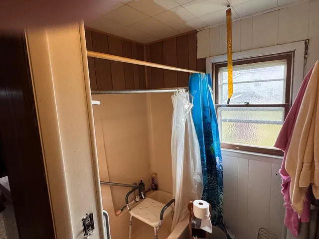 a bathroom with a window and a shower