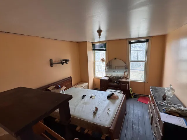 a view of a workspace with furniture and window