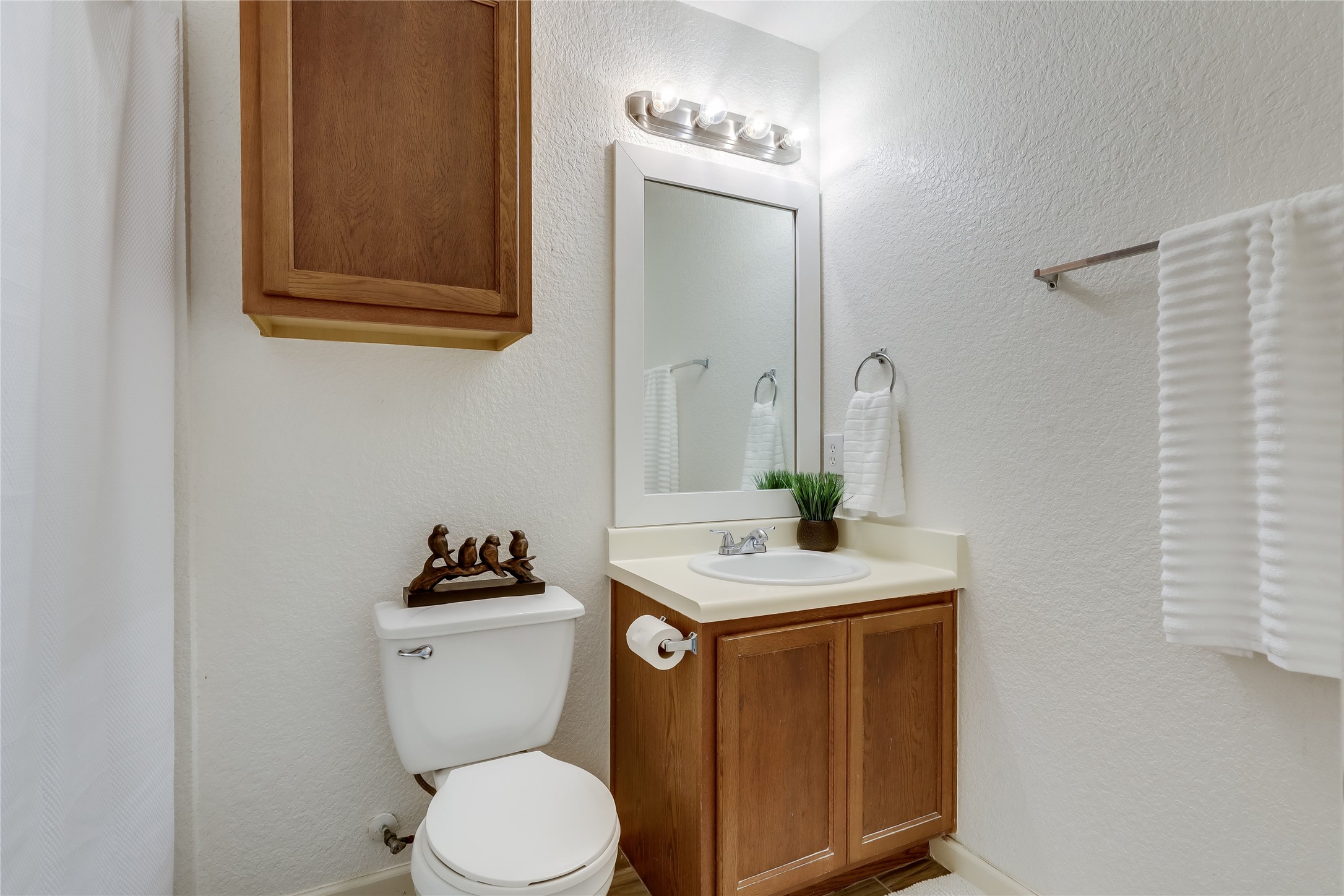 4510 Secure Lane Austin, TX 78725 - Photo 13 of 24 a bathroom with a granite countertop toilet sink and mirror