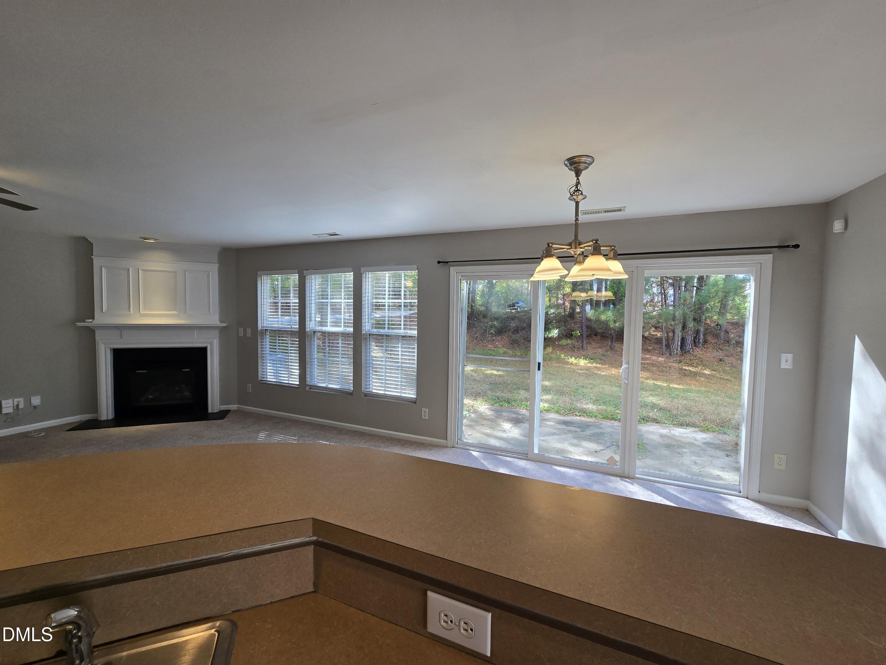 5030 Reservoir Road Raleigh, NC 27610 - Photo 12 of 31 a view of a livingroom with a fireplace and chandelier