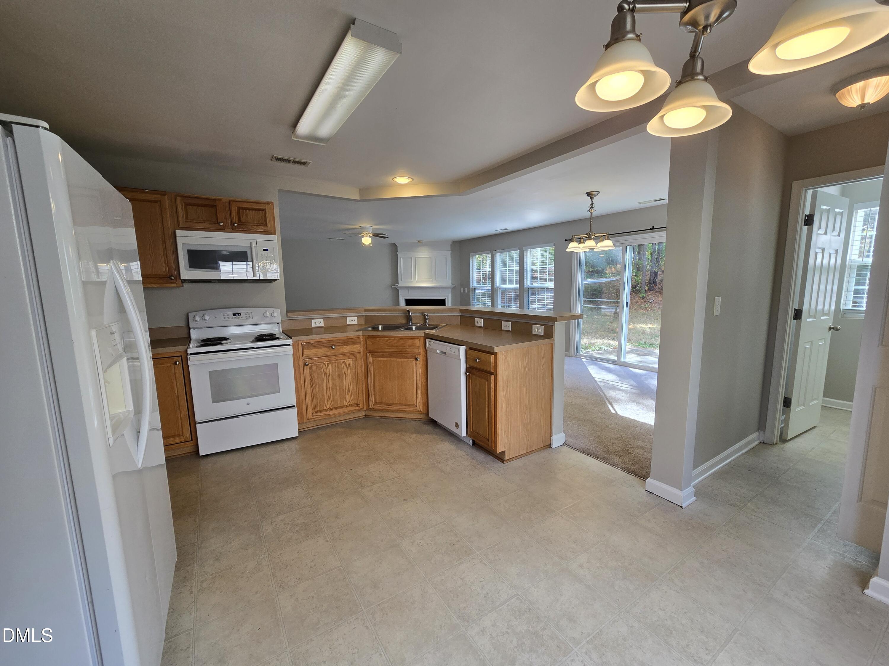 5030 Reservoir Road Raleigh, NC 27610 - Photo 14 of 31 a kitchen with stainless steel appliances granite countertop a refrigerator a stove top oven a sink and dishwasher