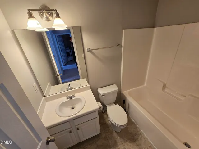 a bathroom with a sink a toilet and bathtub