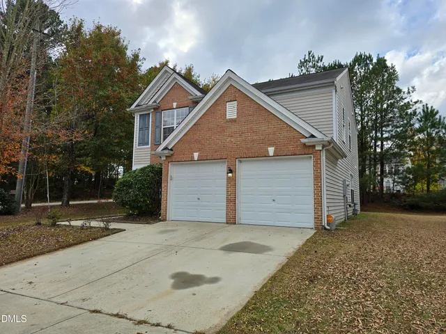 a view of a house with a yard and garage